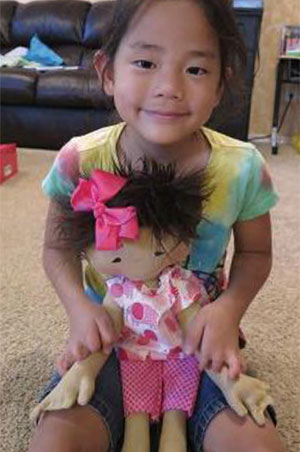 Louanne Mason’s daughter Amelie was adopted from China just before she turned 2. When they brought her home to Texas she didn’t know how to pretend play and had no interest in dolls or stuffed animals. After receiving her Doll Like Me for her 6th birthday, her mother said, “she sleeps with her, takes her everywhere and plays with her like little girls do. It’s been such a blessing to see her bloom in this way and see her delight in the doll that she thanks us for all the time.” 