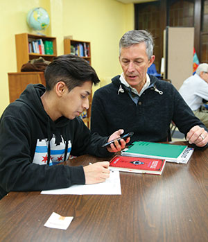 Jasmin Shah Gerardo Geurrero (left) works with Norm Dynneson, who is the facilitator of the weekly tutoring program at Ebenezer.