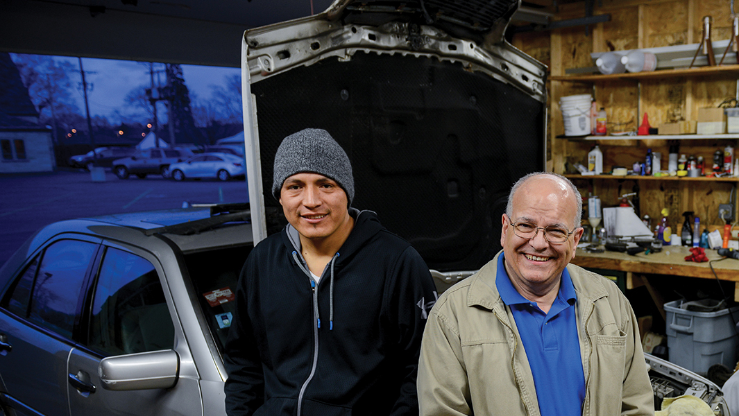 Frank Hauser (right) restored a Dodge truck for Pedro Bunay (left) to use for his roofing business. To say thanks, Bunay voluntarily cleaned and repaired the church's gutters.