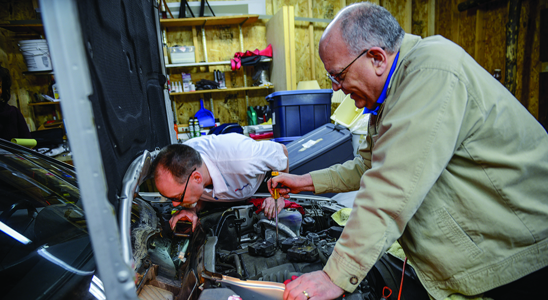 Frank Hauser (right) started Good News Garage about five years ago. He and Kevin Lang (left), the program's volunteer mechanics, have since restored and given away 10 vehicles.