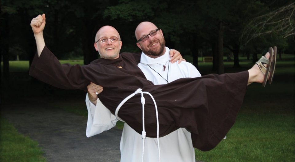 Brother Jeff Steeber, pastor of Christ Lutheran Church, Avon Lake, Ohio, holds Brother Joseph Byrd, Holland, Mich. Steeber is a novice and Byrd is minister of formation for the Order of Lutheran Franciscans.