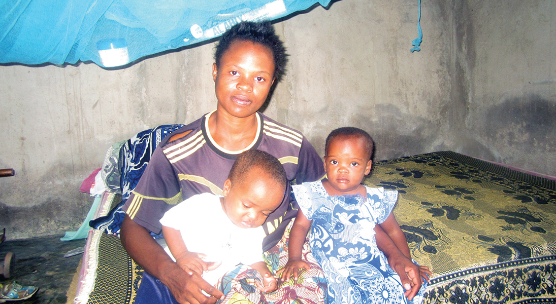 A Tanzanian mother and her two infant children.