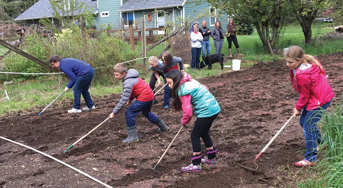 Children hoe a garden