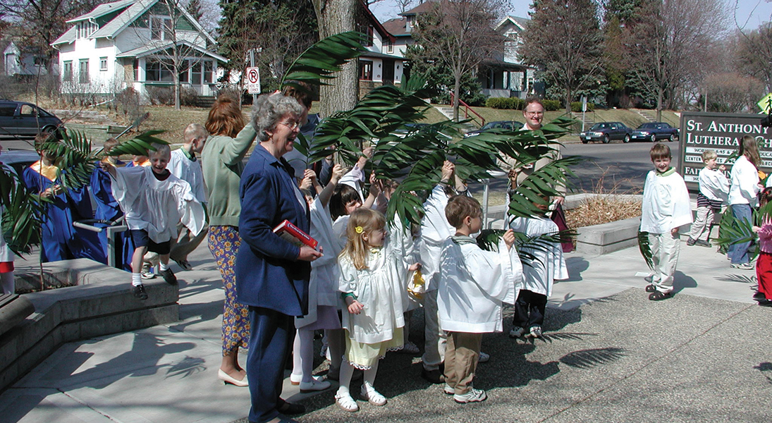 Children wave palm branches on Palm Sunday.