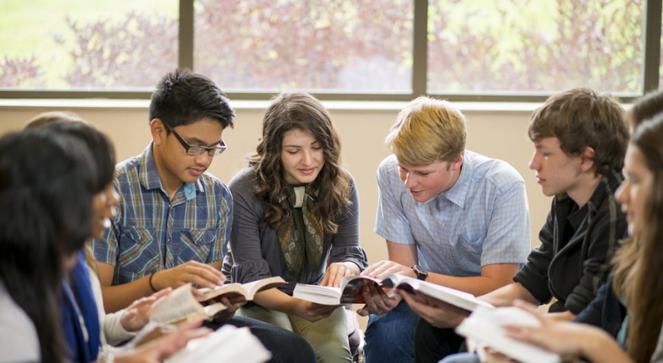 Teens studying the Bible.