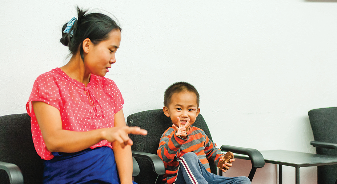 A mother and son practice counting while relaxing at the Village Exchange Center in Aurora, Colo.