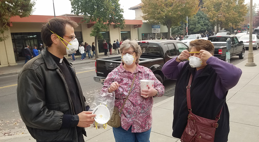 Ben Colohan distributes masks