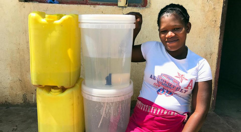 Zikhai Suela from Mpengo Village displays the water filters and gallons distributed by the Lutheran World Federation after Cyclone Idai struck Western Mozambique.