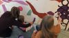 Volunteers of all ages take part in the painting process for the Easter 2019 mural.