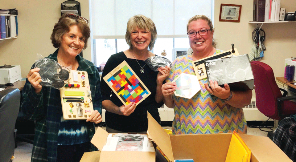 Volunteers hold gifts for seniors.