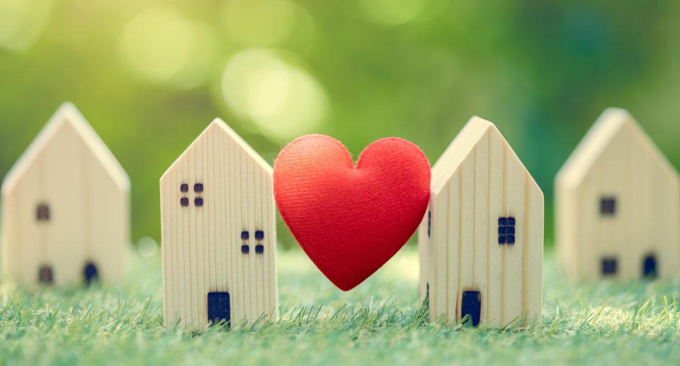 Love heart between two wooden houses