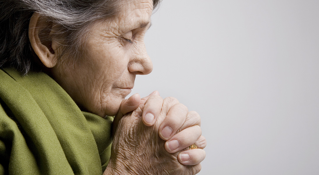 Older woman prays