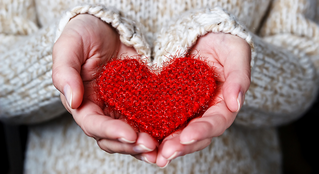 Hands with knitted heart
