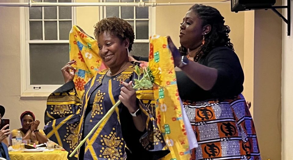 Tammy Jackson (left), ELCA interim executive director for Service and Justice, was presented by Pastor Christina Marthield Montgomery with a Reclaim blanket at the banquet.