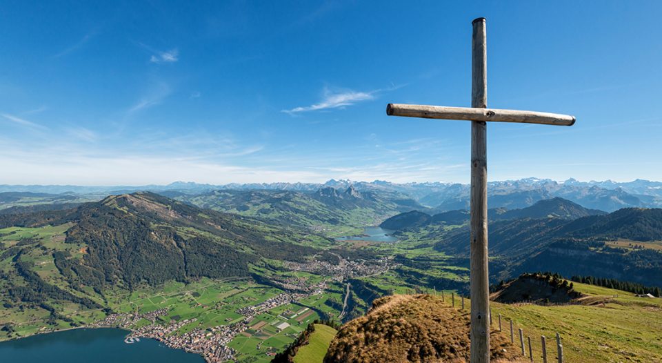 Wooden cross overlooking mountains