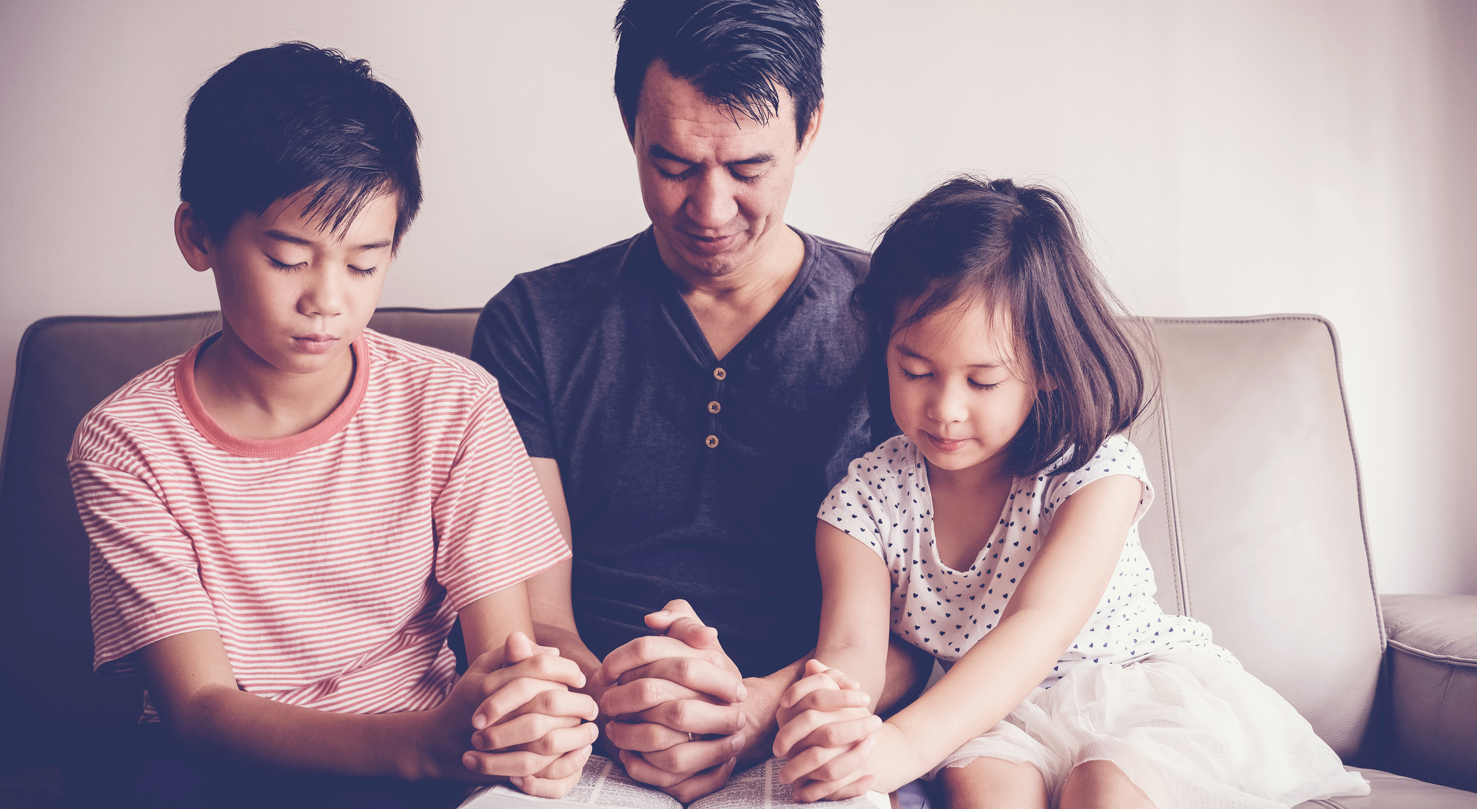 Children pray with father