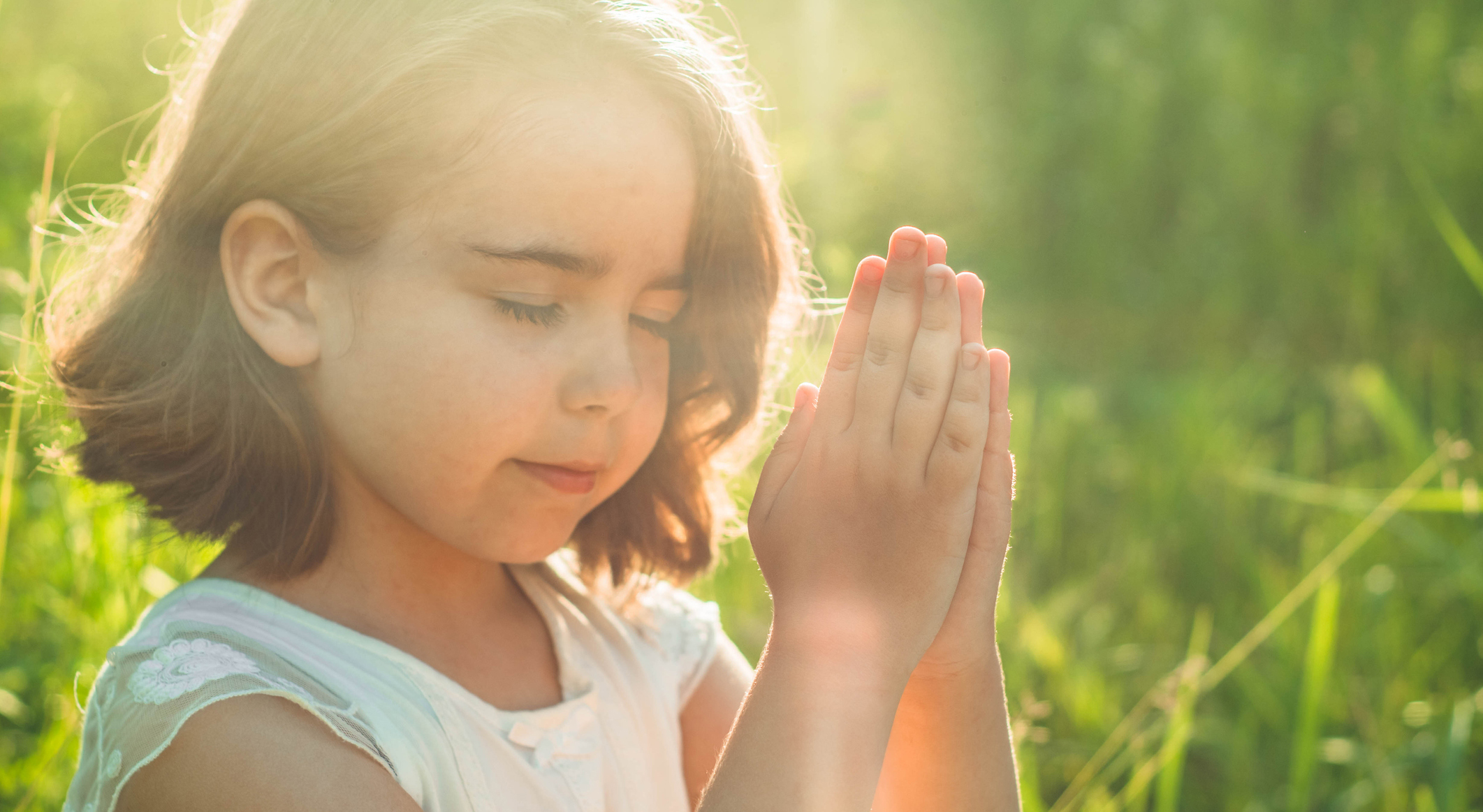 Girl praying in field