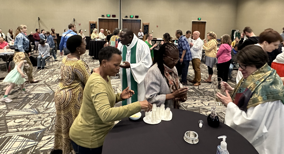 Image of Presiding Bishop Elizabeth Eaton giving communion wine to attendees of the Service and Justice gathering in August 2024.