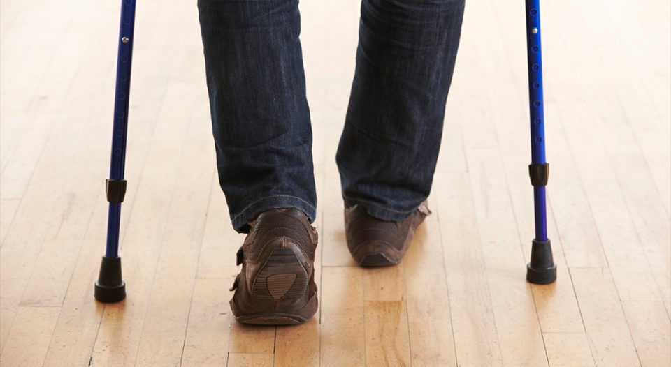 Person walking with two canes