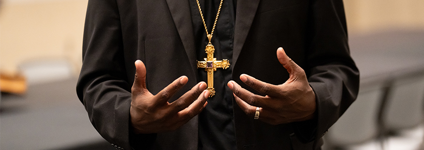 Close up of hands and cross