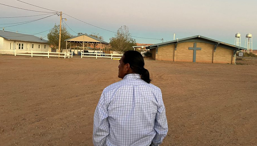 Man standing outside in front of church