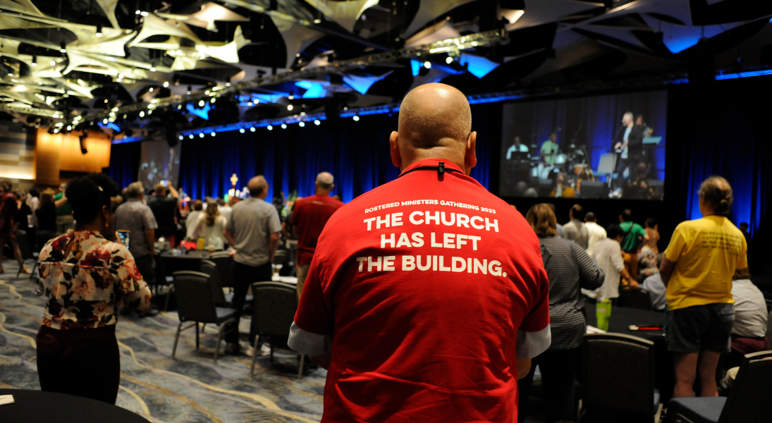 Rostered Ministers Gathering attendee with red shirt that says the church has left the building.