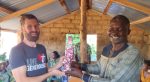 Floribert Ngare (right), a church leader in the ELCA-CAR, presents Matthew Nygard, financial specialist for the Western North Dakota Synod, with a gift in recognition of their companion-synod relationship